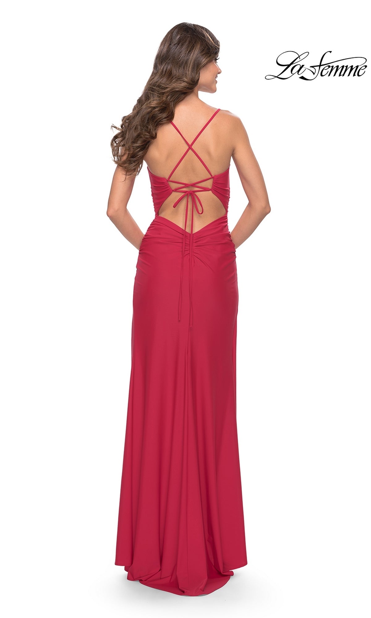 A woman models the La Femme Strappy-Back Long Ruched Prom Dress 31127 in red, featuring a backless design with crisscross straps and ruched details. The La Femme logo appears in the top right corner.